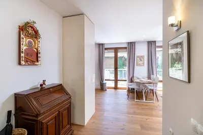a room with white walls and a hallway with a wooden floor at Central 1-bedroom Apartment in Plovdiv