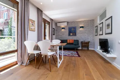 a dining room with a table and white chairs at Central 1-bedroom Apartment in Plovdiv