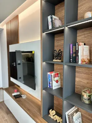 a book shelf with a mirror and books at Apartment G17 in Pernik