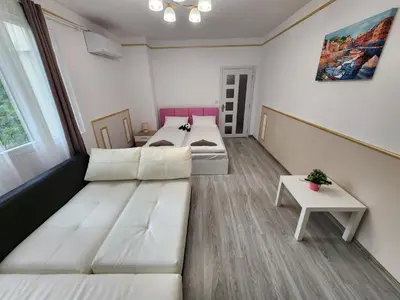 a room with a couch and a bed and a table at luxury two bedroom Crown Apartament in Pravets