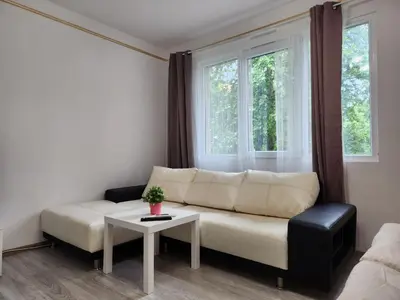 a living room with a white couch and a table at luxury two bedroom Crown Apartament in Pravets