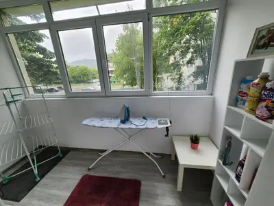 a small room with a table and two windows at luxury two bedroom Crown Apartament in Pravets