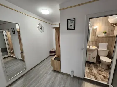 a bathroom with a toilet and a sink and a mirror at luxury two bedroom Crown Apartament in Pravets