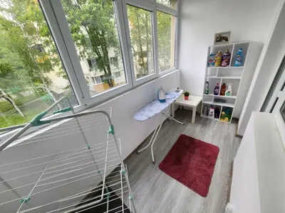 a room with a chair and two windows at luxury two bedroom Crown Apartament in Pravets