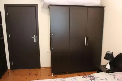 two black cabinets in a bedroom with a bed at Apartment Atanasov - Pamporovo in Pamporovo