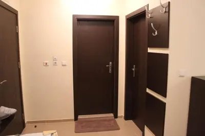 a bathroom with two black doors in a room at Apartment Atanasov - Pamporovo in Pamporovo