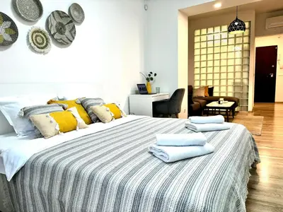 a bedroom with a large bed with towels on it at Cozy Apartment near Vitosha Blvd in Sofia