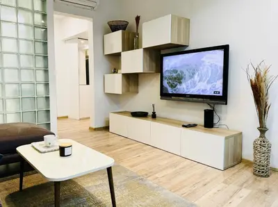 a living room with a flat screen tv on a wall at Cozy Apartment near Vitosha Blvd in Sofia
