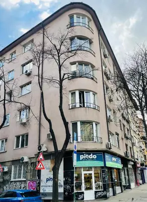 a tall building with a tree in front of it at Cozy Apartment near Vitosha Blvd in Sofia