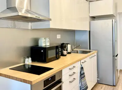 a kitchen with a sink and a microwave at Cozy Apartment near Vitosha Blvd in Sofia