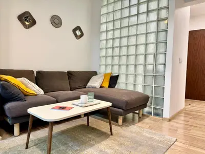 a living room with a couch and a coffee table at Cozy Apartment near Vitosha Blvd in Sofia