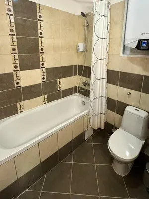 a bathroom with a tub and a toilet and a sink at Sweet Apartment Flora Violet 3 in Borovets