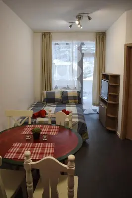 a bedroom with a bed and a table and chairs at Sweet Apartment Flora Violet 3 in Borovets