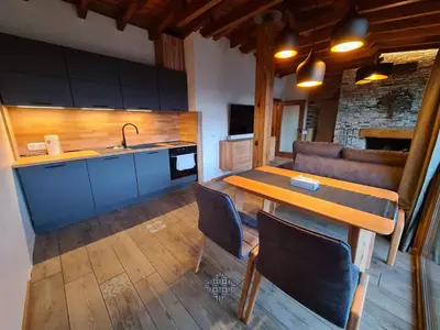 a kitchen and dining room with a table and a sink at Vista Villa at Katarino SPA in Bansko