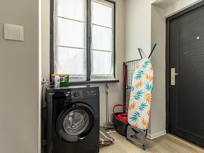 a laundry room with a washing machine and a window at Stay Central: Urban Studio Gem in Sofia