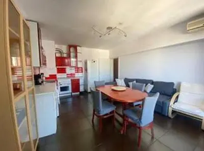 a living room with a table and chairs and a couch at New Two Bedroom apartment with balcony in Sofia