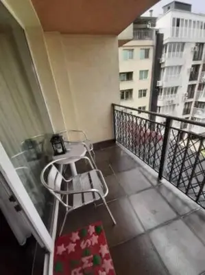 a balcony with a table and a chair on a building at New Two Bedroom apartment with balcony in Sofia