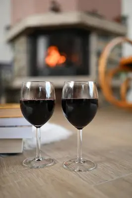 two glasses of red wine sitting on a table at Стаи за гости Ингилизовата къща in Padala