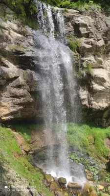 a waterfall on the side of a rocky hill withgrass at Panorama Stoykite Orpheus in Stoykite