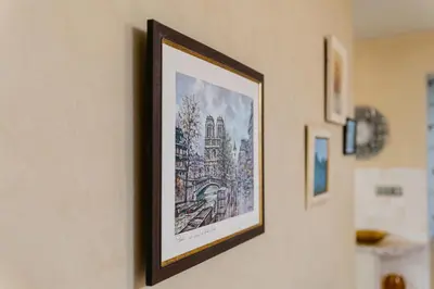 a framed picture of a building on a wall at Elegant 1-Bedroom Apartment in Plovdiv