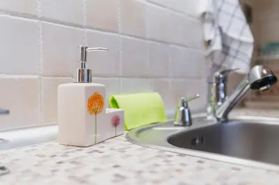 a soap dispenser sitting on a counter next to a sink at Elegant 1-Bedroom Apartment in Plovdiv