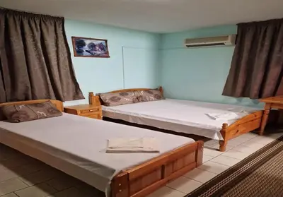 a room with two beds in a room at Хотел Механа Воденицата in Zlatkov Chiflik