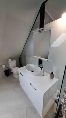 a white bathroom with a sink and a toilet at RCR Einstein studios in Sofia