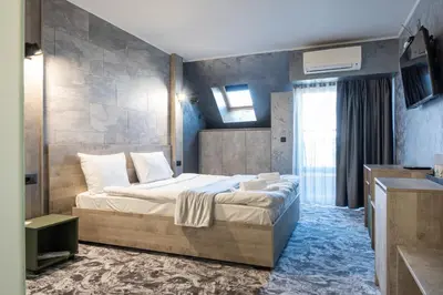 a bedroom with a large bed in a room at RCR Einstein studios in Sofia