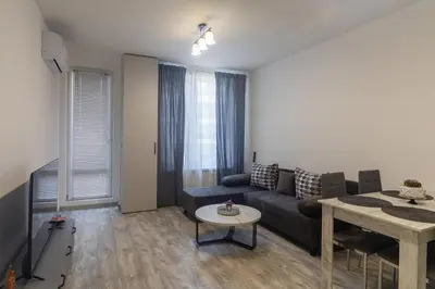 a living room with a couch and a table at Stylish 2 BDR Apartment at an Excellent Location in Sofia