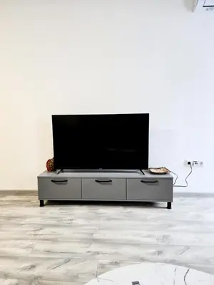 a flat screen tv sitting on a entertainment center in a living room at Stylish 2 BDR Apartment at an Excellent Location in Sofia