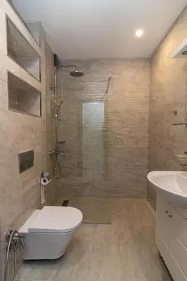 a bathroom with a shower and a toilet and a sink at Stylish 2 BDR Apartment at an Excellent Location in Sofia