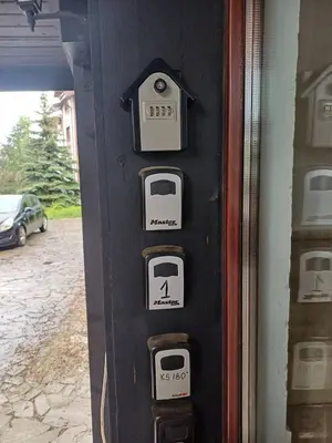 a ticket machine with clocks on the side of a building at Apartament Armada Bansko in Bansko