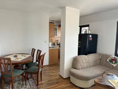 a living room with a couch and a table at Apartament Armada Bansko in Bansko