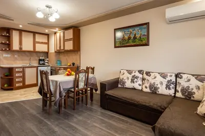 a living room and kitchen with a couch and a table at Апартамент за гости ВениАн in Velingrad