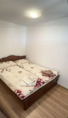 a bed sitting in a corner of a room at Apartment Danik River Glaznel in Bansko