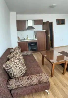 a living room with a couch and a table at Apartment Danik River Glaznel in Bansko