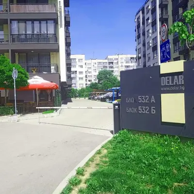 a sign in front of a building next to a street at Alis Savana in Sofia