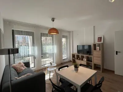 a living room with a couch and a table at Idea Apartment in Sofia