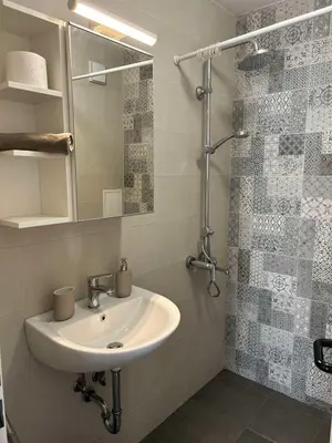 a bathroom with a sink and a mirror at Idea Apartment in Sofia