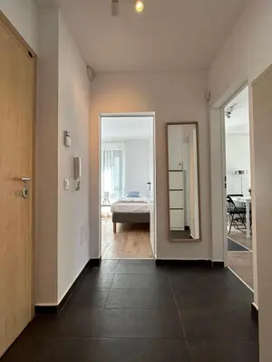 an empty room with a bed and a mirror at Idea Apartment in Sofia