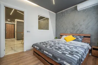 a bedroom with a bed with a yellow pillow on it at Cozy Homes 4 in Sofia