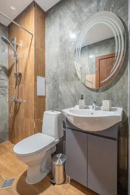 a bathroom with a toilet and a sink and a mirror at Cozy Homes 4 in Sofia
