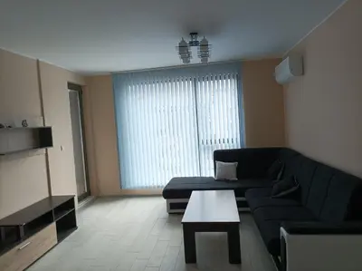 a living room with a couch and a table at Мариана in Plovdiv