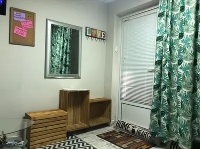 a living room with a window and a curtain at Studio for guests Catherine in Sofia