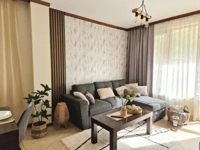 a living room with a couch and a table at Cozy apartment in luxury SPA resort St Ivan Rilski Bansko -free wellness & parking- in Bansko