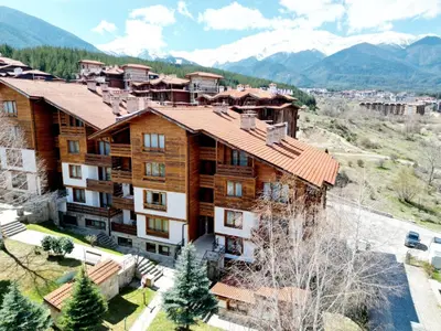 an aerial view of a building with mountains in the background at Cozy apartment in luxury SPA resort St Ivan Rilski Bansko -free wellness & parking- in Bansko