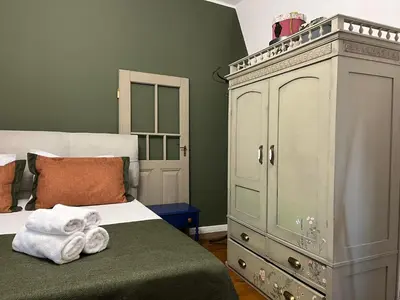 a bedroom with a bed and a large cabinet at Diva Kapana 2BDR Apartment with parking in Plovdiv