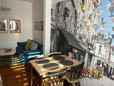 a dining room with a table and a painting on the wall at Diva Kapana 2BDR Apartment with parking in Plovdiv