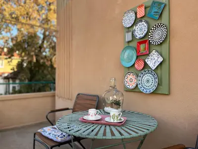 a table with plates and cups on a wall at Diva Kapana 2BDR Apartment with parking in Plovdiv