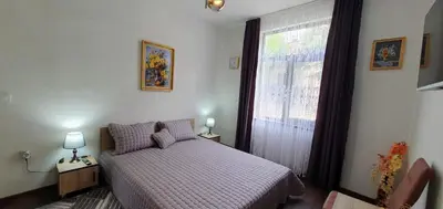 a small bedroom with a bed and a window at АПАРТАМЕНТ ЮЛИЯ ДЕЛУКС II in Velingrad